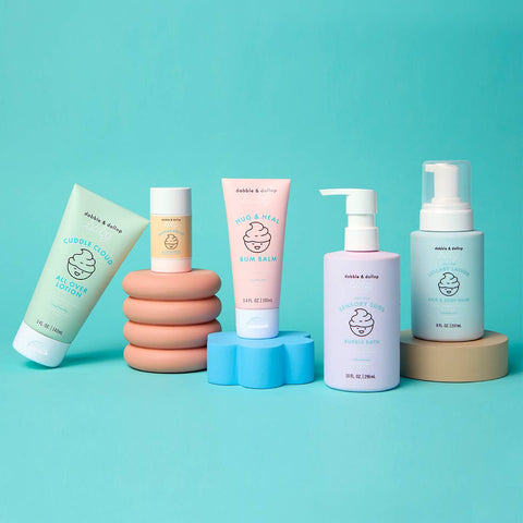 Collection of baby care products on a teal background