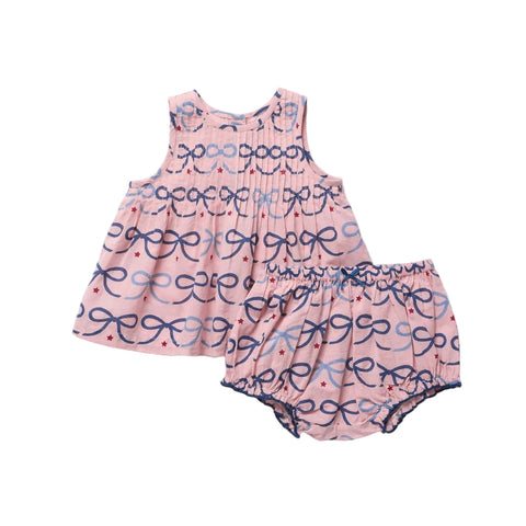 Pink baby dress with bow pattern on a white background