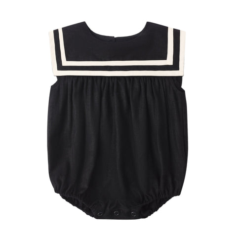 Black baby romper with white trim on a white background